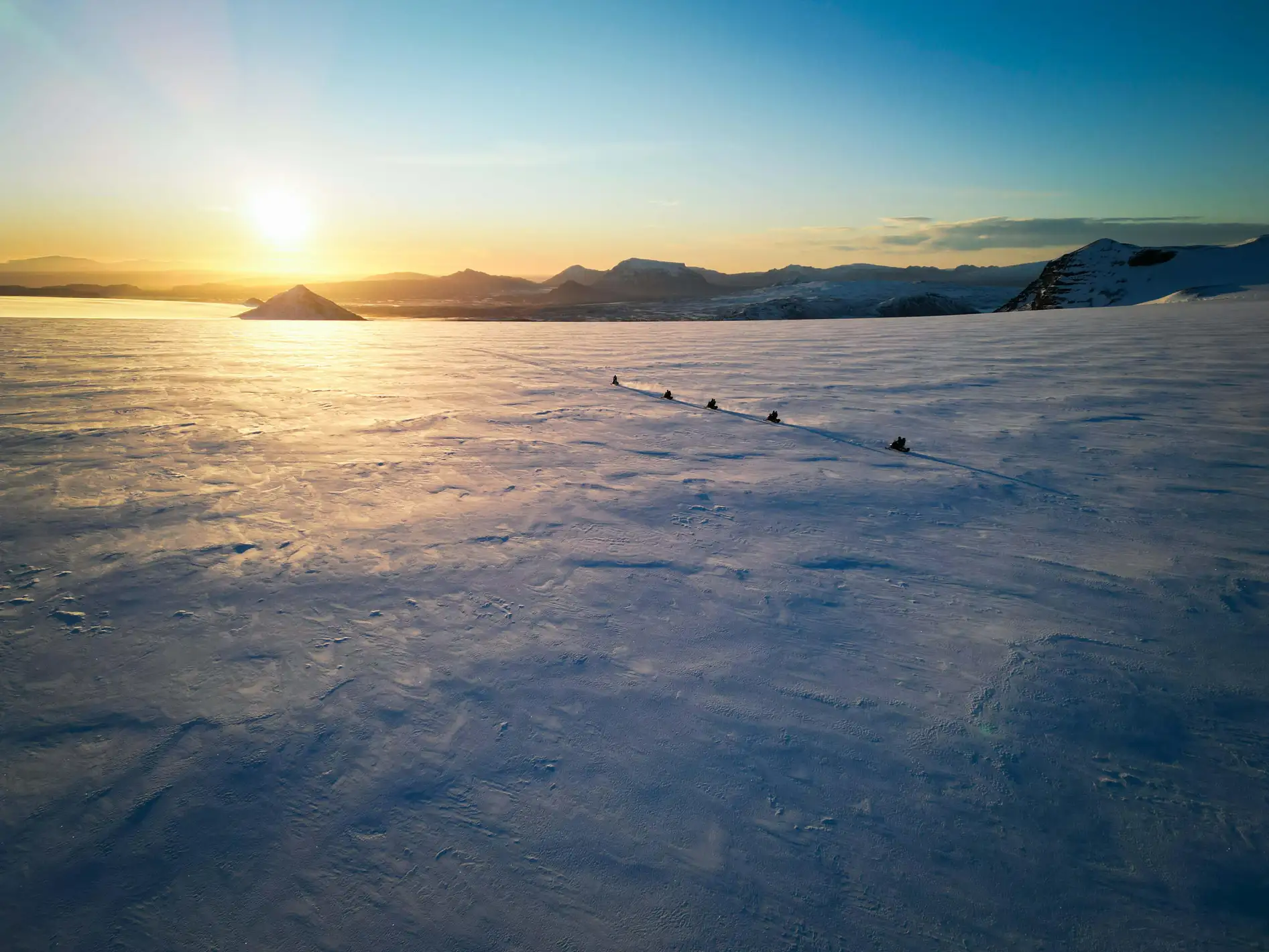 Group of friends snowmobiling in Iceland
