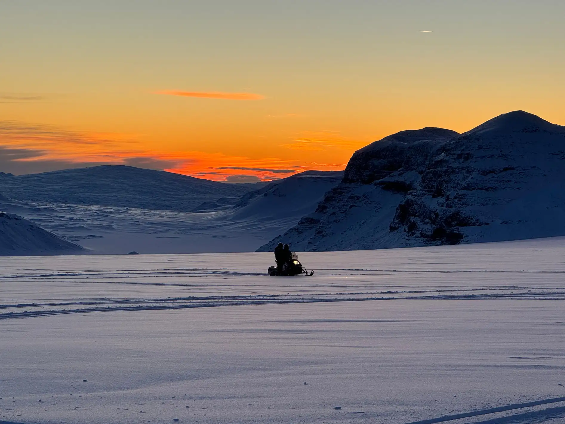 Close-up of snowmobile tracks in fresh snow